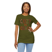 Woman wearing a green t-shirt with 'COZY IN CHAOS' text on a white background