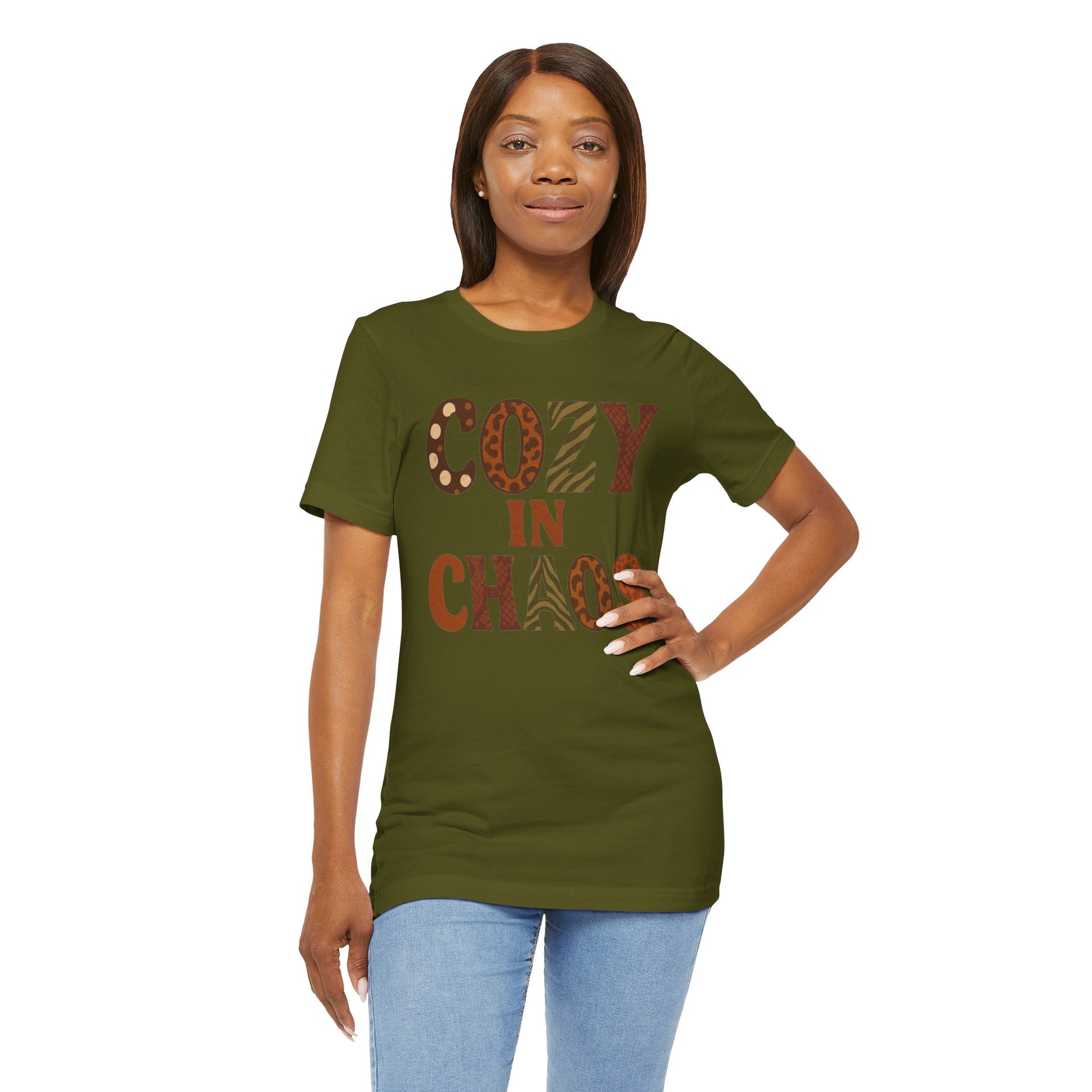 Woman wearing a green t-shirt with 'COZY IN CHAOS' text on a white background