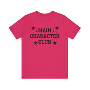 Pink t-shirt with 'MAIN CHARACTER CLUB' text and stars on a white background