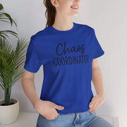 Person wearing a blue t-shirt with 'Chaos Coordinator' text, standing indoors.