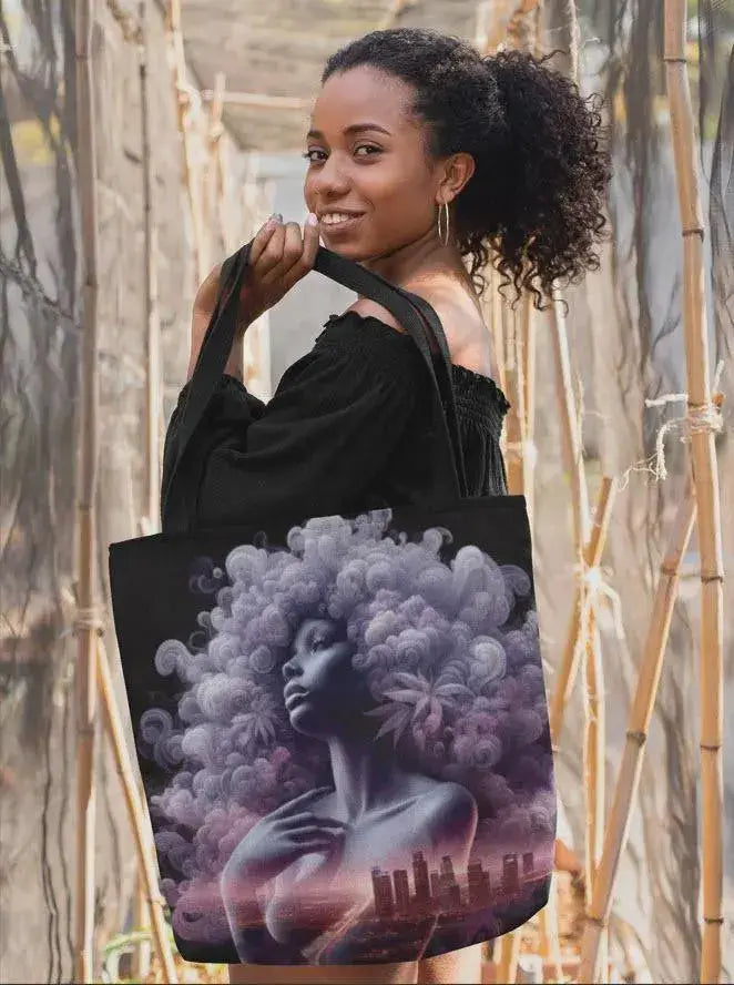 Woman holding a tote bag with a artistic design of a woman with clouds.
