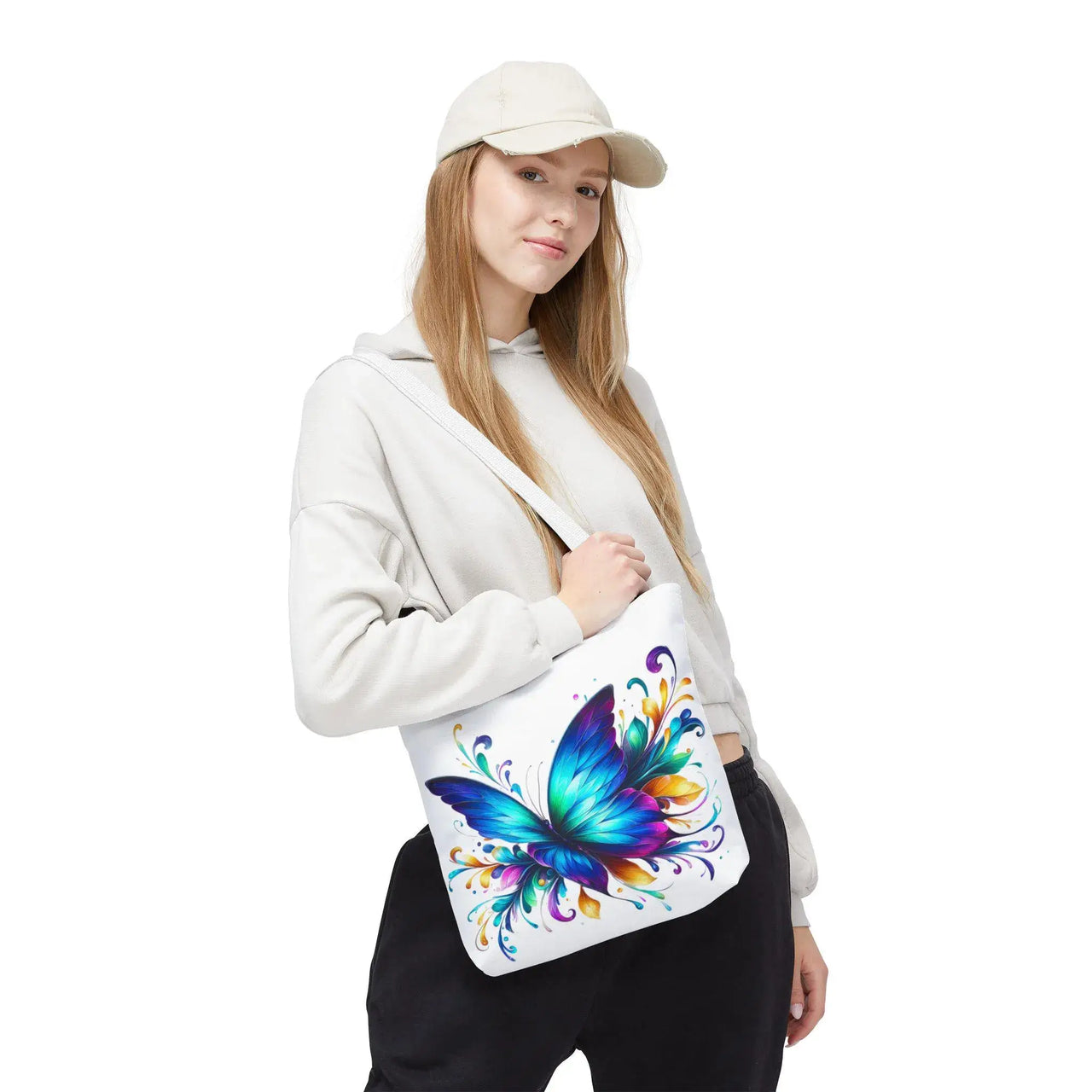 Person wearing a white hoodie with a colorful butterfly design on a shoulder bag.