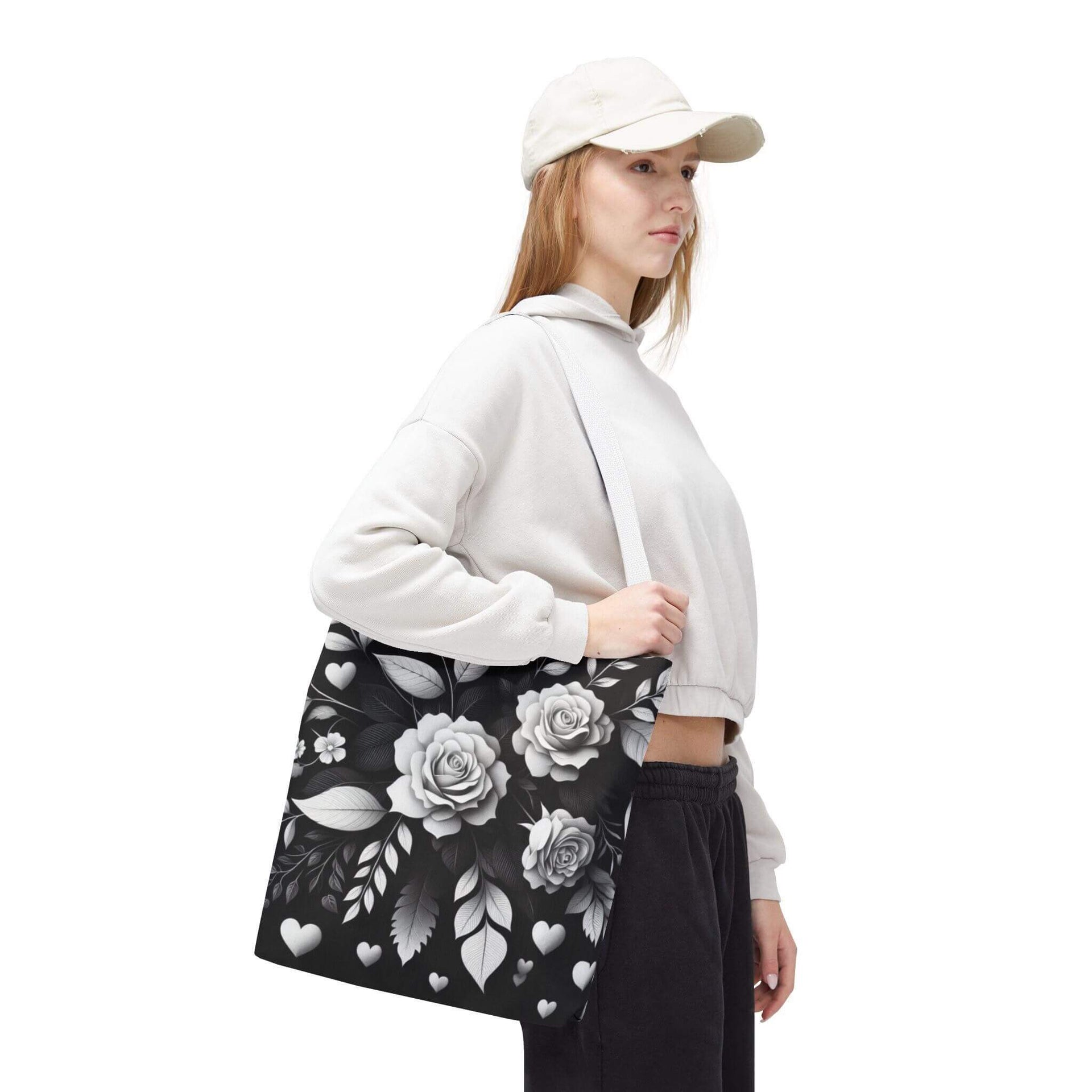 Person wearing a white hoodie and black floral skirt with a white cap on a white background