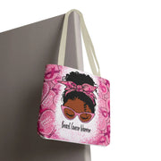 Pink tote bag with a graphic of a woman wearing sunglasses and a headband, with 'Breast Cancer Warrior' text, on a gray background.