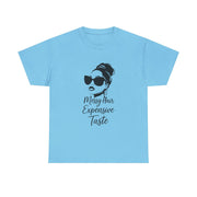 Light blue t-shirt with a graphic of a woman with messy hair and sunglasses and text on a white background